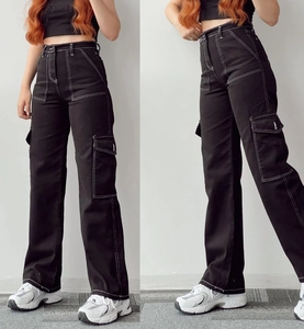 Detail of black high-waist cargo pants featuring white contrast stitching and side pockets