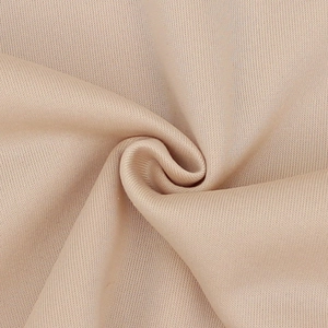 Close-up of beige high-elastic knit fleece fabric showing soft texture and fine grain
