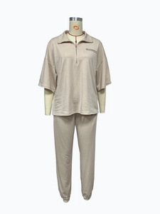 Detail of Mai Studios Co. print on beige short sleeve lapel top and matching pants set