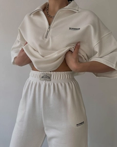 Detail of half-zip short sleeve sweatshirt and joggers with MAI STUDIOS CO. branding