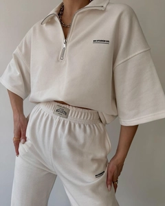 Detail of cream sweatshirt and joggers with MAI STUDIOS logo and high-quality cotton texture