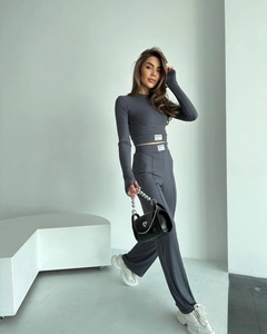 Close-up of dark grey ribbed knit fabric texture on long sleeve crop top and wide-leg pants