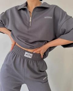 Detail of the high-quality gray cotton texture and white printed logo on the casual set