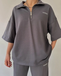 Detailed texture of heavy cotton dark grey sweatshirt and trousers set with white logo