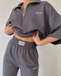 Close-up of semi-zipper collar and white logo print on high-quality grey knit set