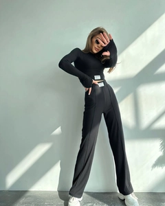 Detail of ribbed knit texture on black two-piece set featuring New Design label and finger holes