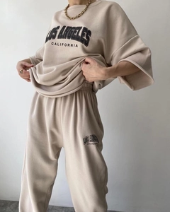 Detailed view of Los Angeles letter print on beige cotton sweatshirt and jogger set