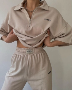 Detail of apricot lounge set featuring half-zip sweatshirt and wide-leg joggers texture