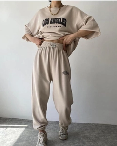 Detail of beige oversized tracksuit featuring Los Angeles California graphic print