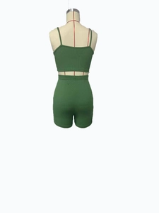 Rear view of green ribbed knit yoga set showing cropped cami top and high waist shorts