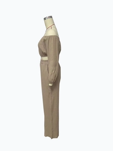 Detail of khaki off-shoulder long sleeve crop top and matching textured trousers