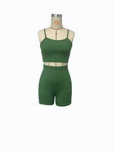 Detail of green ribbed knit two-piece set featuring a cropped camisole and high-waist shorts