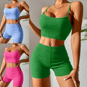 Detail of ribbed knit texture on a crop top and high-waist shorts set in green and blue