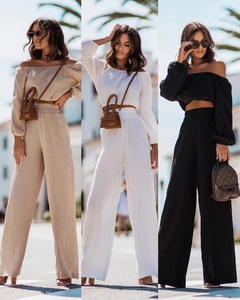 Three-color collage of off-shoulder crop tops and wide-leg trousers in a resort setting