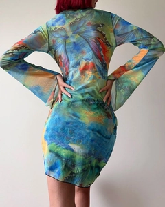 Detail of sheer mesh dress featuring a large vibrant butterfly print and flare sleeves