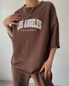 Detail of Los Angeles print on oversized brown cotton short sleeve hoodie and shorts set