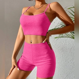 Detail of ribbed knit fabric on rose red crop top and high waist yoga shorts set