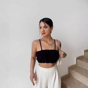 Sexy black ruffle crop top and white high-waisted wide-leg trousers fashion outfit