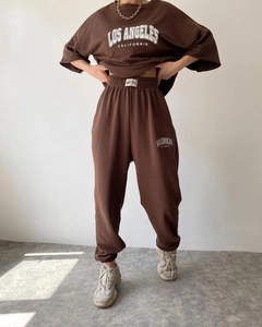 Detail of Los Angeles printed short sleeve sweatshirt and high waist joggers in brown