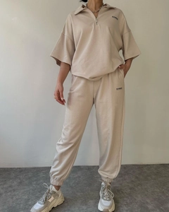 Detail of beige two-piece lounge set with short sleeve zipper top and joggers