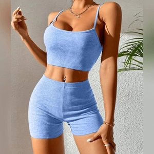 Detail of light blue ribbed yoga set featuring cami crop top and high waist shorts