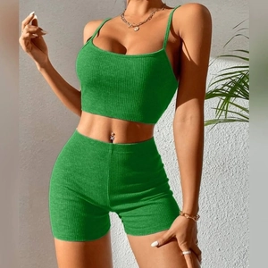 Close-up of green ribbed yoga set featuring a cami crop top and high waist slim shorts
