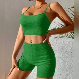 Detail of lime green ribbed knit crop top and high waist shorts workout set
