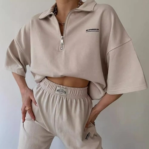 Minimalist beige two-piece lounge set with half-zip sweatshirt and matching joggers