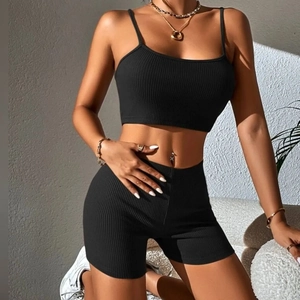 Detail of black ribbed knit two-piece set featuring camisole top and high-waist shorts