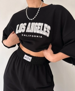 Detail of Los Angeles print sweatshirt and elastic waistband with brand woven label