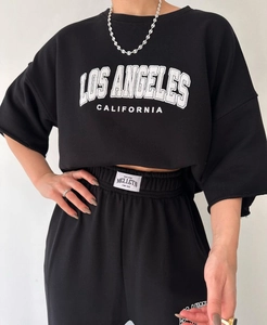 Detail of Los Angeles print on short sleeve sweatshirt and branded waistband tag