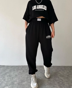 Detail of Los Angeles print on black cropped short sleeve hoodie and jogger set