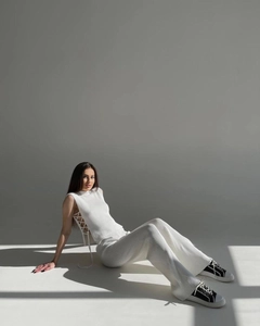 Detailed view of the side lace-up design on the white rib-knit sleeveless vest top