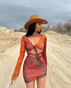 Detail of Y2K tie-front crop top and bodycon skirt in vibrant orange mesh print