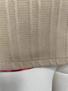 Detailed macro view of khaki woven fabric with vertical stripes and fine stitching