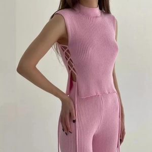 Pink knit two-piece set with sleeveless mock neck top and slim trousers for women