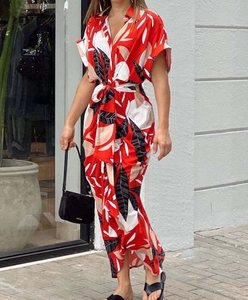Detail of red tropical leaf print shirt dress with adjustable waist tie for summer wear