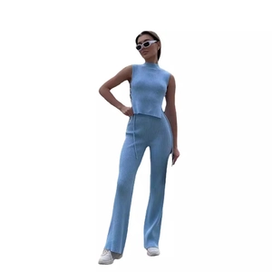 Women's light blue knit two-piece set featuring ribbed crop top and flared trousers