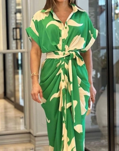 Detail of single-breasted shirt dress with green print, short sleeves and waist belt
