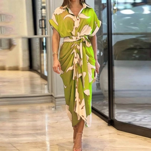 Detail of green floral print shirt dress with button-down front and waist tie