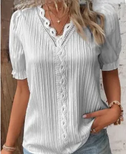 Detail of white hollow V-neck blouse with textured vertical pleats and lace trim details