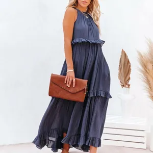 Detail of dark blue halter dress showing tiered ruffles and linen texture for vacation