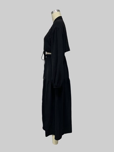 Detailed view of black crinkled texture long sleeve lace-up top and layered skirt set