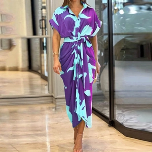Detail of single-breasted printed shirt dress with short sleeves and waist tie belt