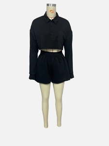 Detail of black long-sleeve crop polo top and elastic waist shorts in soft jersey fabric