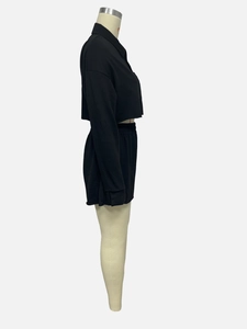 Detail view of black long sleeve cropped shirt and elastic waist shorts two-piece set