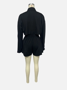 Detailed back view of a black two-piece casual set featuring a crop top and elastic shorts