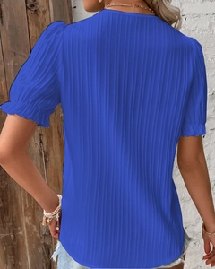 Detail of blue short sleeve shirt with pleated texture and stylish puff sleeves back view