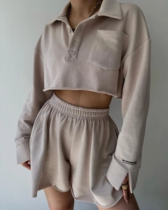 Detail of oatmeal long sleeve cropped polo sweatshirt and drawstring shorts set