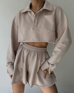 Detail of light khaki long sleeve cropped polo sweatshirt and drawstring shorts set